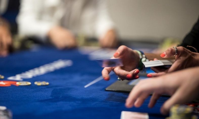 Gros plan sur des mains jouant au poker, illustrant l'action à la table.